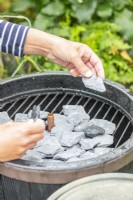 Woman placing pieces of slate on the grill