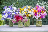 Four different bouquets on a wooden table