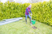 Woman digging out a shallow trench