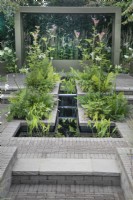 Water feature in the hard landscaping in the 'Macmillan Legacy Garden: Gift the Future' at RHS Hampton Court Palace Garden Festival 2022