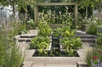 Symmetrical water feature in the 'Macmillan Legacy Garden: Gift the Future' at RHS Hampton Court Palace Garden Festival 2022