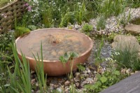 Copper water feature set amongst gravel planting - The Hide Garden, RHS Malvern Spring Festival 2022