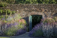 Open gate in walled garden, edged with Lavender, mid summer