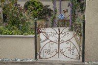 Decorative metal gate in the shape of a butterfly in the Metamorphosis garden at BBC Gardener's World Live 2022