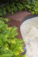 Overhead view of an inner city courtyard garden with inbuilt curved composite timber bench seating.