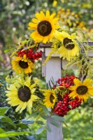 Wreath made of sunflowers, rowan berries and goldenrod.