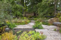 Urban garden with cobble path leading through drought tolerant planting - The M and G Garden, RHS Chelsea Flower Show 2021