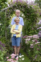 Couple in their cottage garden in July.