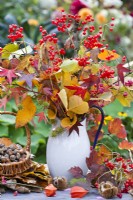 Autumn leaf and berry bouquet containing guelder rose and sweet gum