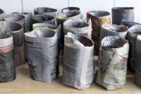 Making planting pots for seedlings from old newspapers. 
Once the pot moulds have been created the paper is dampened to make the mould stick and then the pots are left to dry.