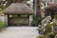 Thatched pavilion at Enys garden, Cornwall in May