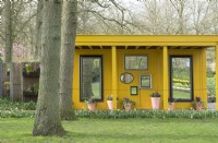 Yellow wooden gazebos decorated with several mirrors.