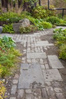 Cobble path leading through perennial and grasst planting. Design: Harris Bugg Studio