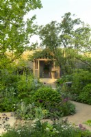 Herbaceous borders surrounding a pegged oak garden room in the RBC Brewin Dolphin Garden designed by Paul Hervey-Brookes at the RHS Chelsea Flower Show 2023.