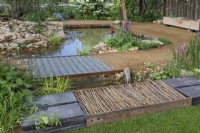 Recycled metal grille over the water feature in The Wildlife Trusts: Wilder Spaces garden at RHS Malvern Spring Festival 2023
