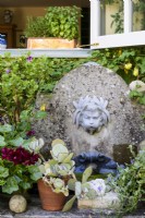 Water feature with cherub spouting water into a shell at Castle Rings, Dorset, in August