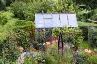 Seedpod garden at Falkners Cottage, Wiltshire in September with Seed Pod by Ted Edley and planting in orange and purples