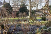 Sunshine on frosted border with snowdrops at Downton House, Gloucestershire