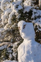 The garden at Gravetye Manor, Sussex, in winter. A snowman 