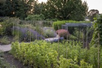 Cutting and vegetable garden in large walled kitchen garden with fruit cage behind