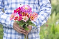 Man holding a bouquet of Zinnia Cactus and Whirlygig Mixed