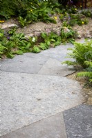 Fossilised Chatsworth stone path on The Boodles British Craft Garden designed by Thomas Hoblyn, Sanctuary Gardens - RHS Chelsea Flower Show 2023