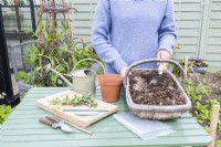 Woman mixing grit and compost in trug