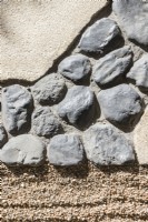 Detail of chequerboard design surface with raked gravel surface imitating rippling water known as Samon , cobbled stone and paving slabs. 