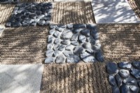 Chequerboard design surface with raked gravel surface imitating rippling water known as Samon , cobbled stone and paving slabs. 
