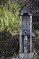 Decorative 1920s water pump in the walled garden at Parham House in September