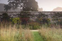 Hot border in the walled garden at Parham House in September