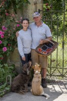 Helena Whibley and Tom Coward at Gravetye Manor, with harvested fruit in the walled garden