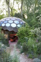 A path leads to the domed structure surrounded with planting for pollinators in The Royal Entomological Society Garden - Designer: Tom Massey -Sponsor: Project Giving Back -