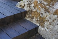 Wooden steps made with reclaimed timber cladding built to mould around boulder.