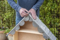 Step-by-Step Making a Plant Theatre. Step 24: carefully fit the lead to the roof, overlapping the central scalloping beneath the flap which is rolled up. 20mm is allowed to bend over the back edge, protecting the edges of the marine ply from rain