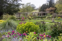 Tulips, euphorbia and forget-me-nots in the spring borders at Gravetye Manor.