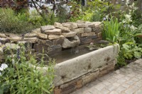 Old cattle trough used as a water feature in Old is Gold at BBC Gardeners World Live 2022, June
