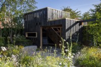 Wildlife observation hide building with living green roof - mixed perennial and wildflower planting 