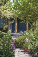 Designer Chris Beardshaw RNLI Garden at RHS Chelsea Flower Show 2022 with pavilion and stone path, herbaceous perennials