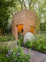 The timber garden room, a stone cairn and herbaceous planting beds at Horatio's Garden, Chelsea Flower Show 2023. Designer: Charlotte Harris and Hugo Bugg, Gold medal winner, Best Show Garden