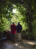 Couple looking at gardens from elevated viewpoint