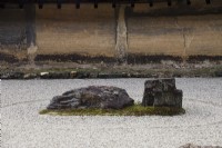 The Rock Garden with raked gravel and placed stones in moss island. Walls of clay.