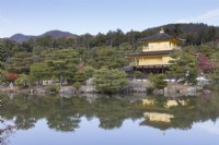 View to Golden Pavilion across the Kyoko pond and Asihara island. Pine trees on island.