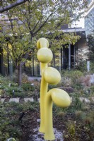Yellow painted metal abstract sculpture in the Sprouting Garden. 