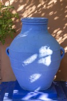 A blue painted amphora, terracotta container in Jardin Majorelle, Yves Saint Laurent garden
