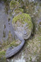 Head of stone Buddha with moss