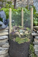 Wire mesh and wood post circular compost bin for vegetable garden waste.

'Food For Thought'

Small Garden Silver Medal Winner at Bloom Garden Festival Ireland 2014 

Design: Elma Fenton