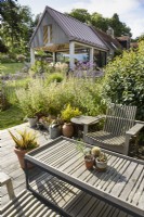Wooden table and seats in a country garden in July