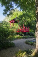The red wooden pergola set among bamboo in The Thai Garden at The Manor, Little Compton.