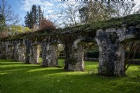 Stone arches, the remains of an ancient building in the grounds of Dartington Hall, Devon